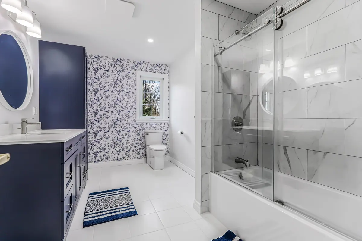 A focused vanity update with coordinated blue paint, tile and hardware.