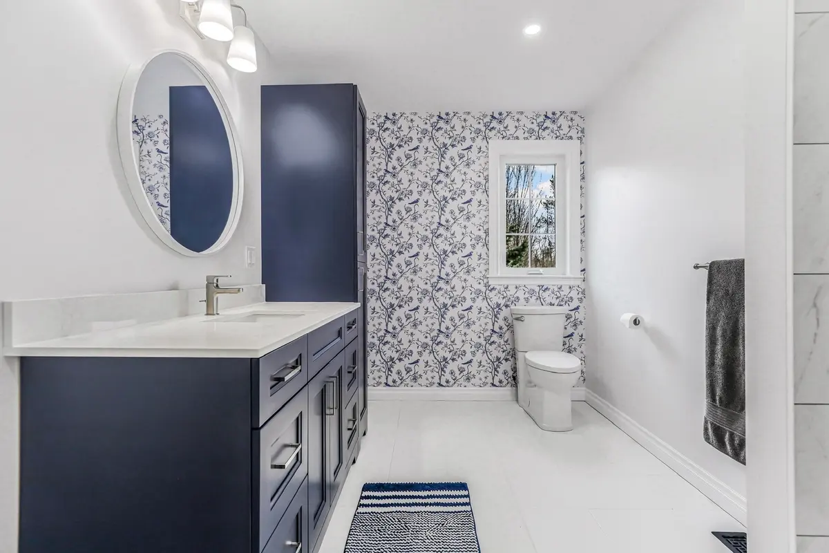 A design-aware bathroom finish combining paint, wallpaper, vanity and lighting selections.